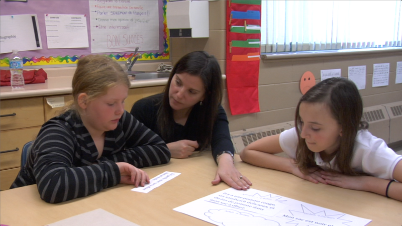 Image of students with teacher taken from "Shared and Guided Practice (Core French Elementary)" video